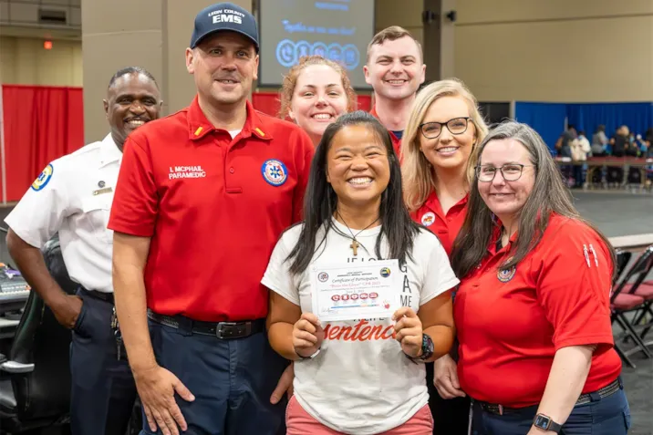 EMS staff pose with a citizen