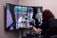 Library staff showcases the CAT Excavator simulator, a hands-on workforce training tool in the Career Corner hub.