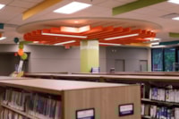 Colorful ceiling baffling and updated signage in the Media section create a brighter, easier-to-navigate space for library visitors.
