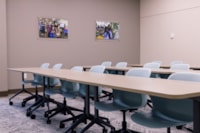 One of three new meeting rooms on the renovated second floor, equipped with tables, seating, and presentation technology for community use.