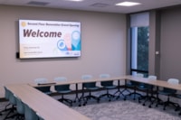 Meeting Room A offers seating for up to 24 and features dual large monitors with computer access for presentations, study, and collaboration.