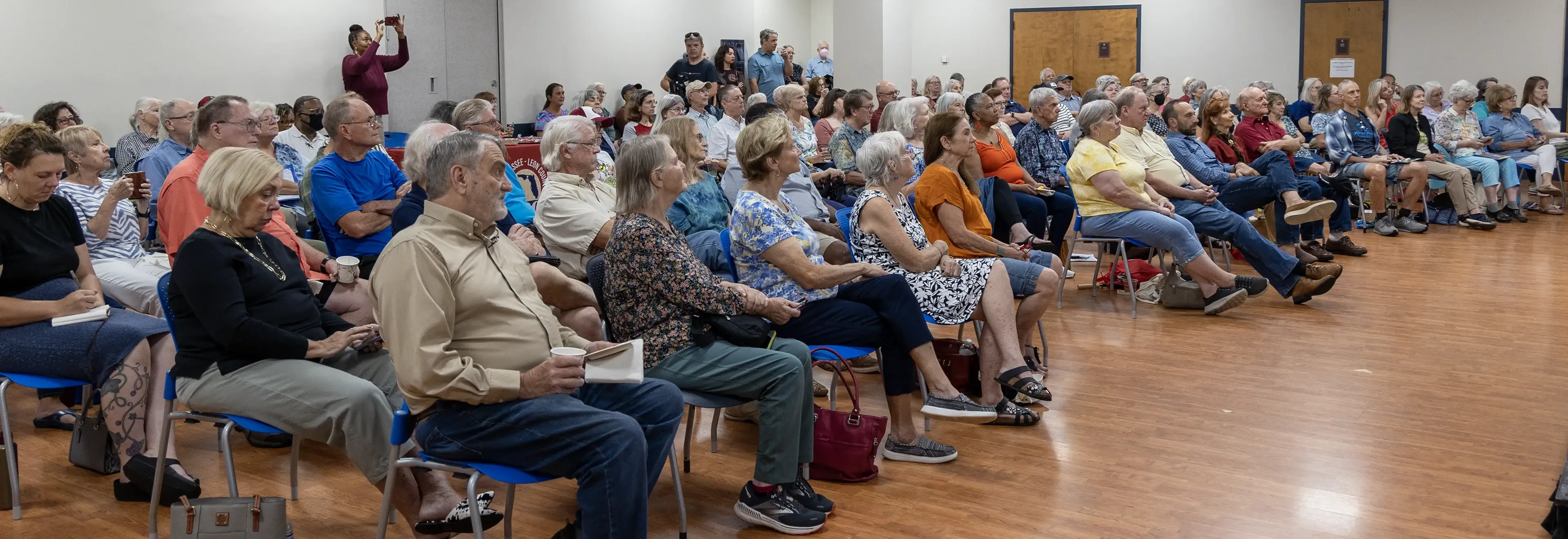 An audience listens to a lecture at the library