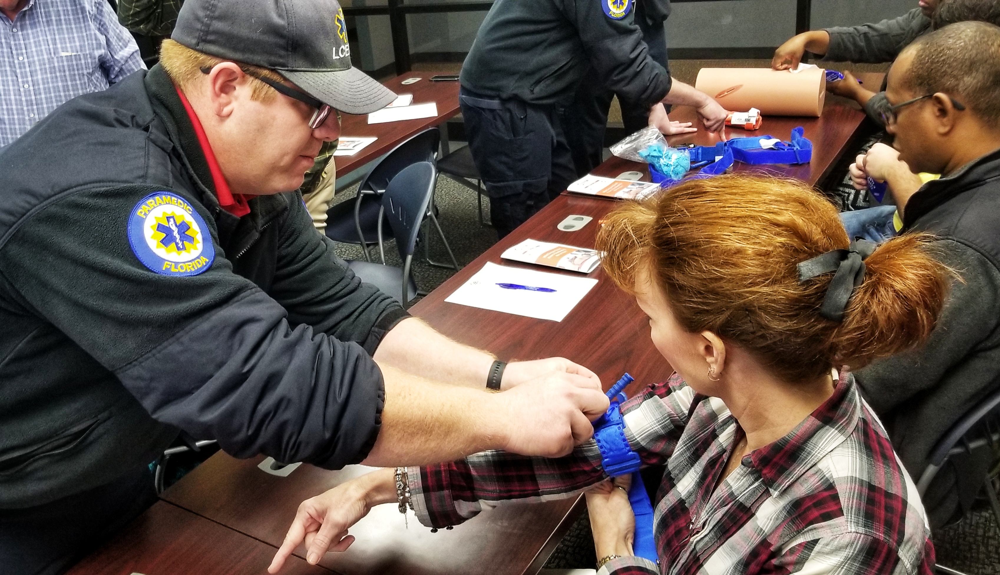20181211_103359-01 Leon County EMS staff member teaching a citizen how to control bleeding.