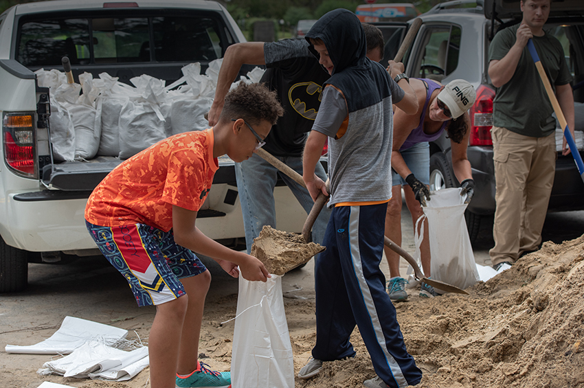 Image of children filling sandbags 
